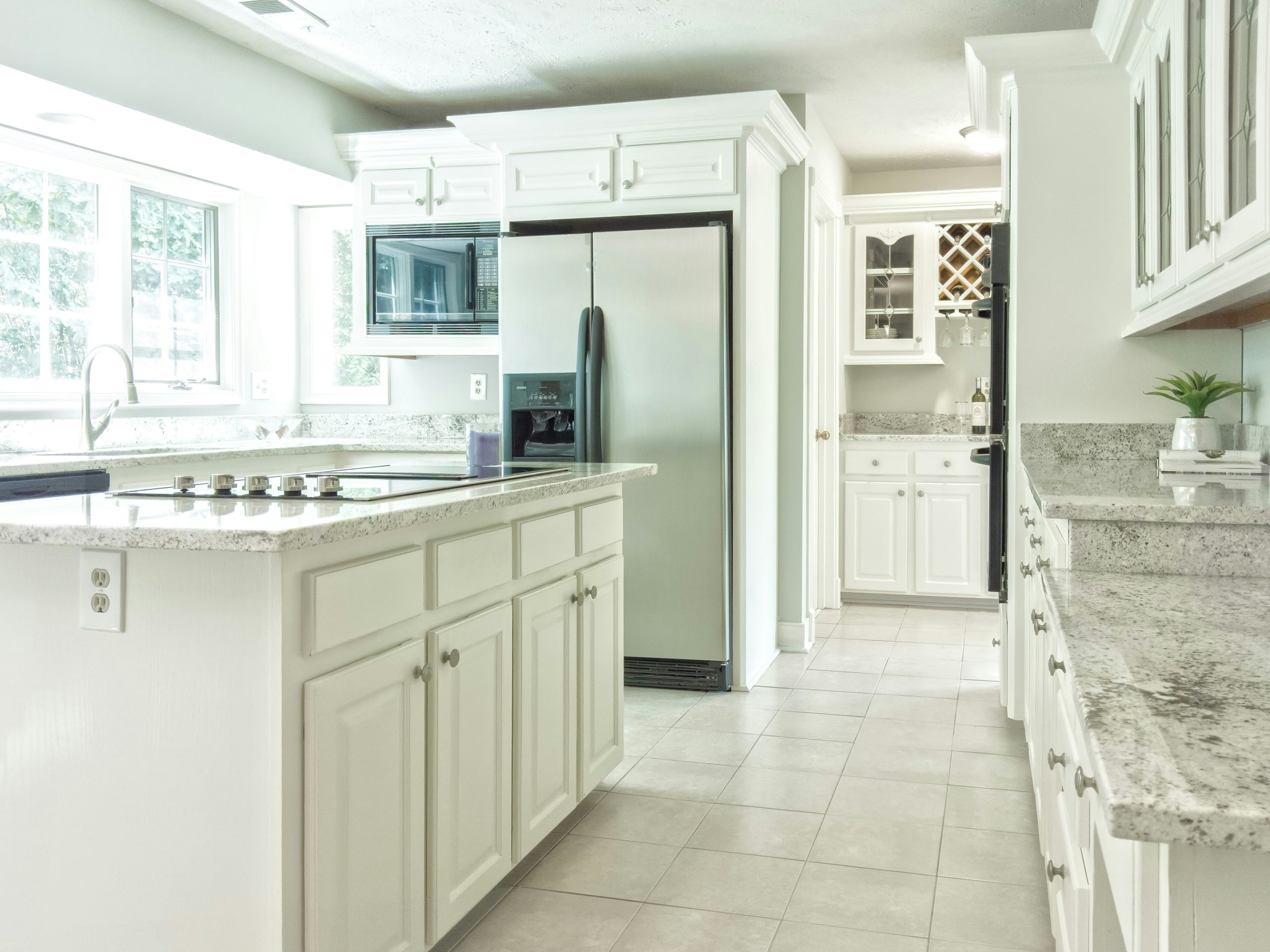 Luxury kitchen interior with white cabinets and granite countertops